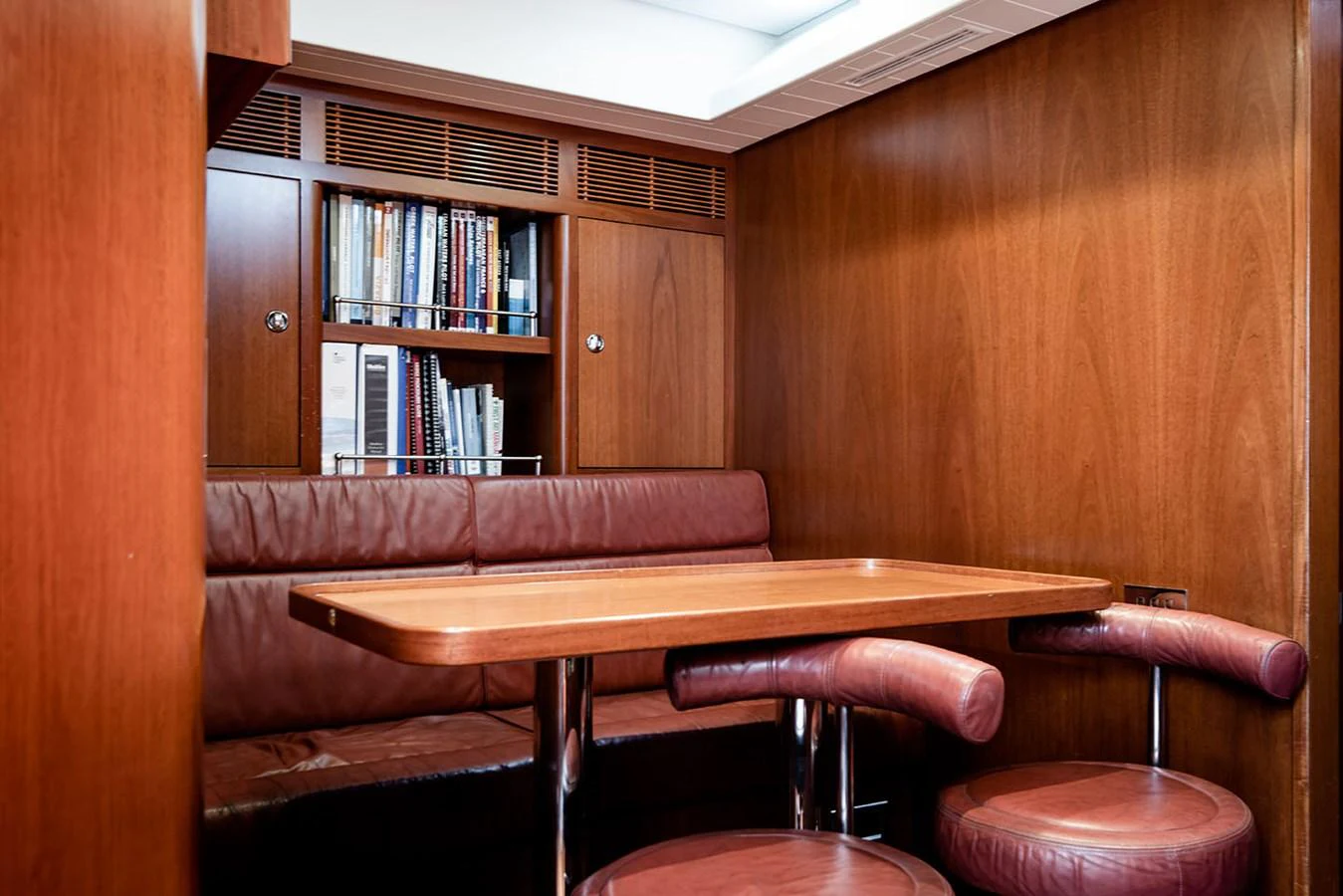 a couch and a table in a room aboard PATH Yacht for Sale