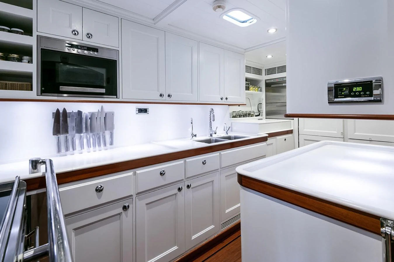 a kitchen with white cabinets aboard PATH Yacht for Sale