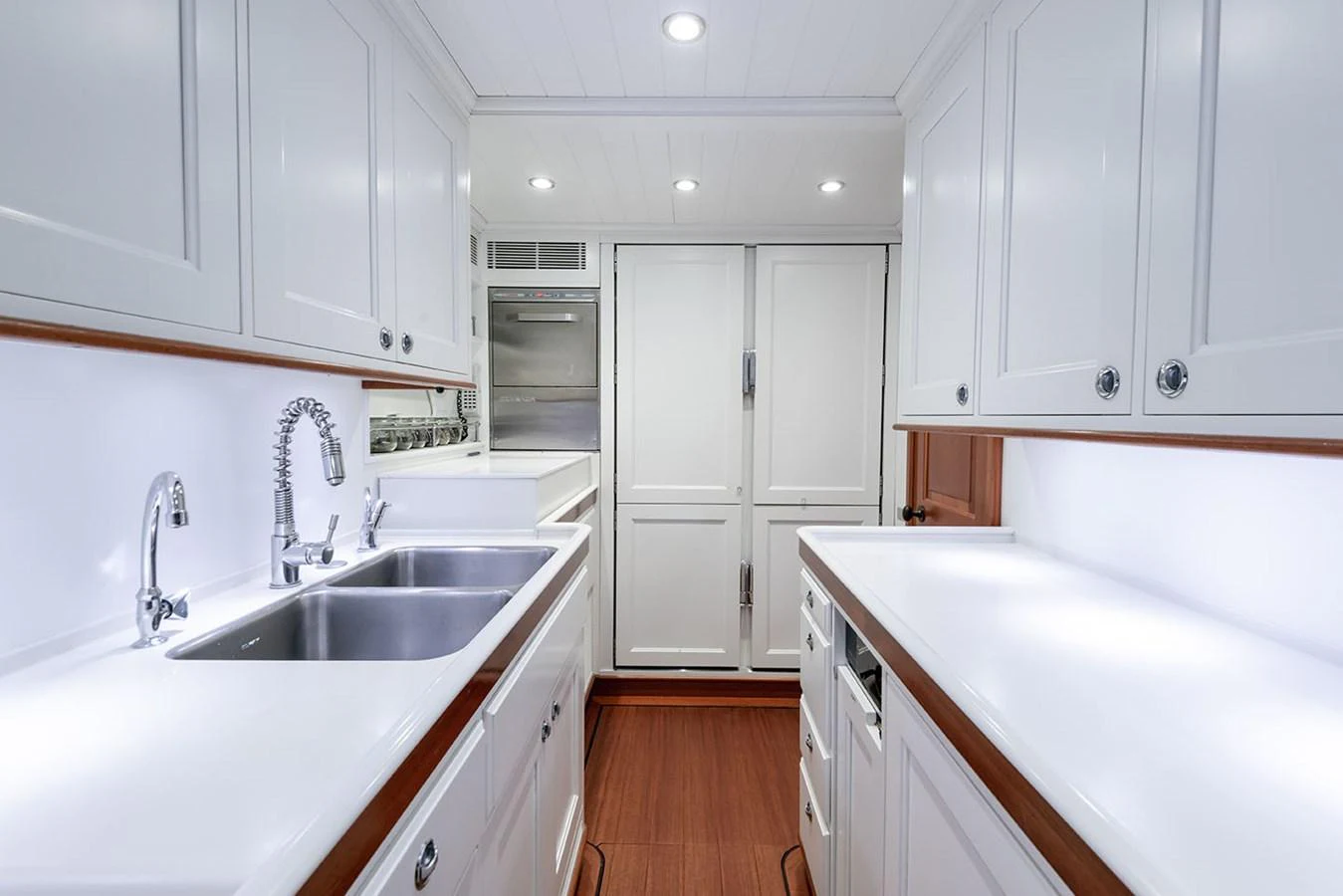 a kitchen with white cabinets aboard PATH Yacht for Sale