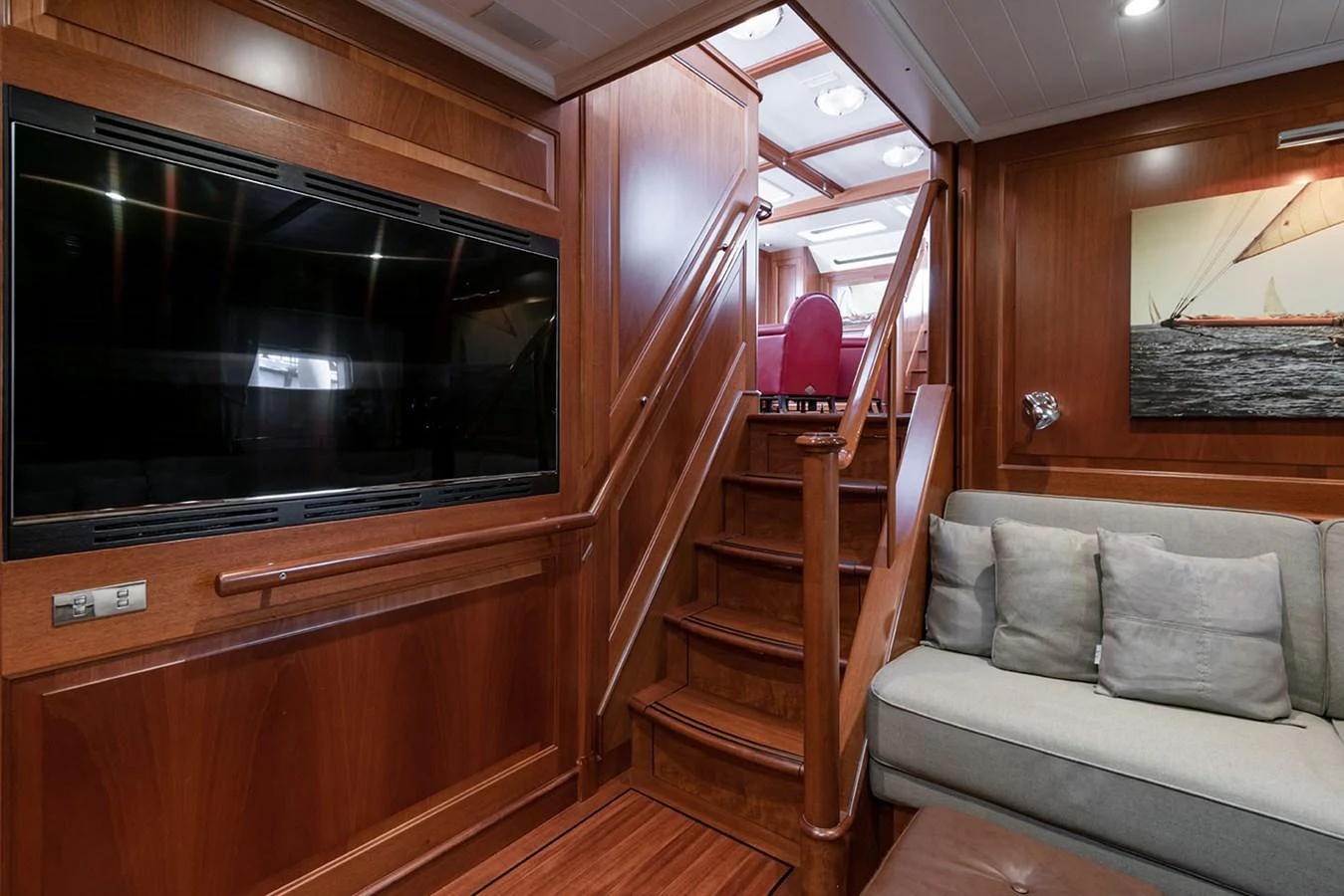 a living room with a couch and a staircase aboard PATH Yacht for Sale