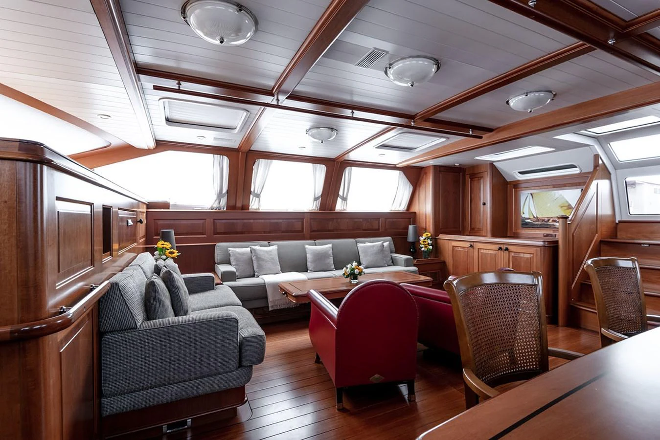 a living room with a couch and a table aboard PATH Yacht for Sale