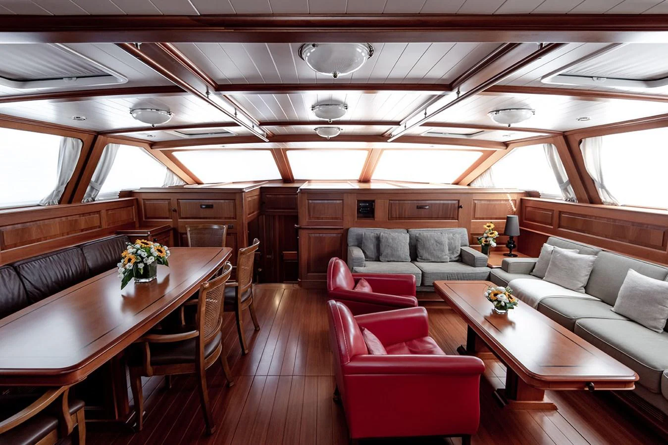 a living room with a couch and a table aboard PATH Yacht for Sale
