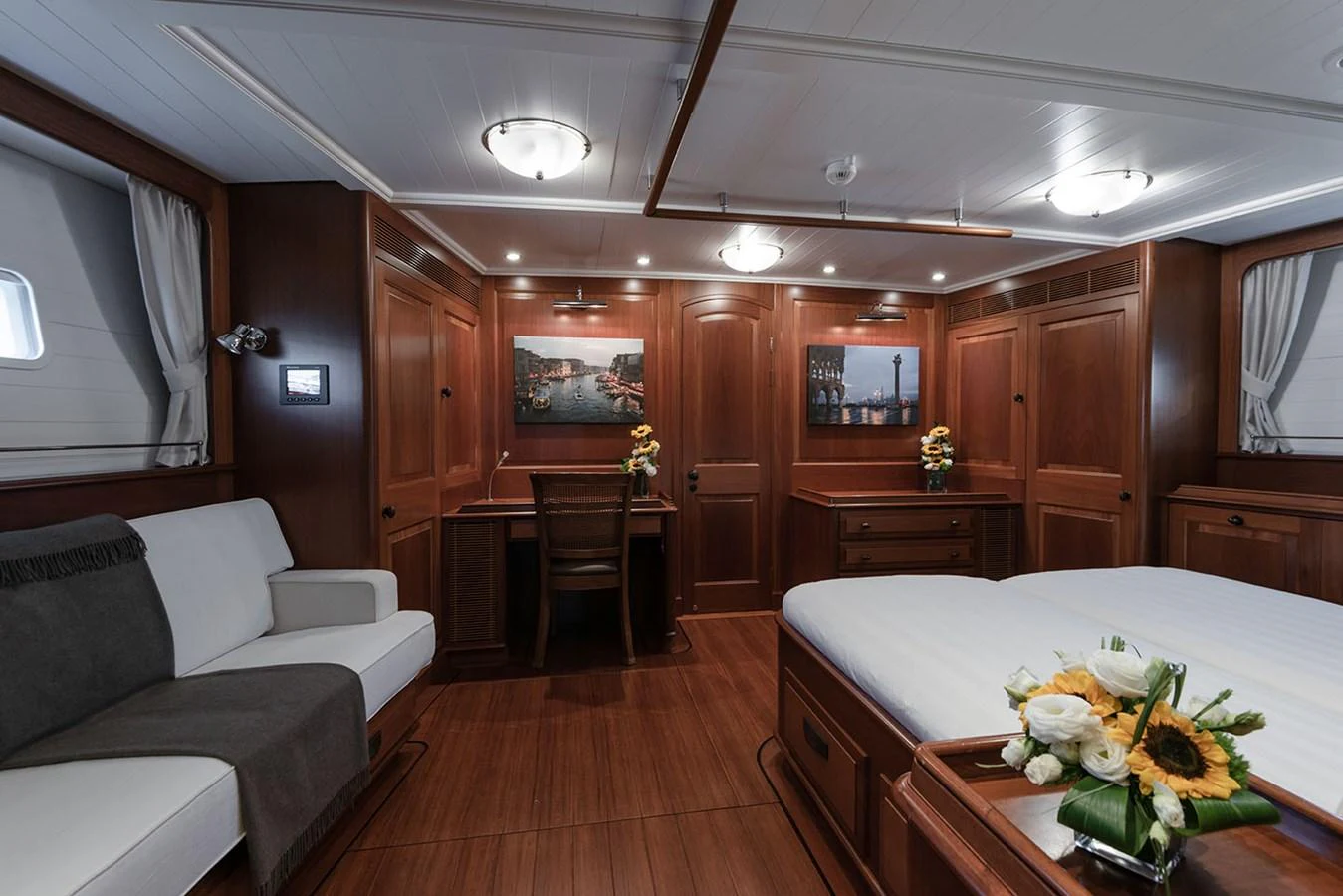 a living room with a couch and a table aboard PATH Yacht for Sale