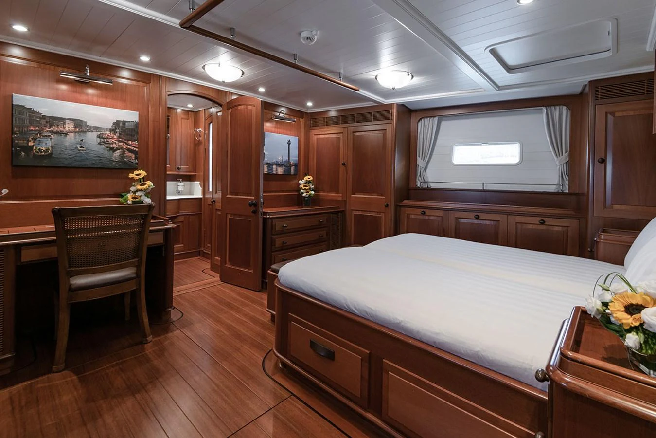 a large bedroom with a large bed aboard PATH Yacht for Sale