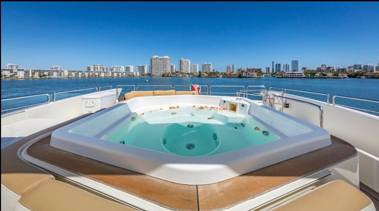 a pool on a deck overlooking a city aboard AVA Yacht for Sale