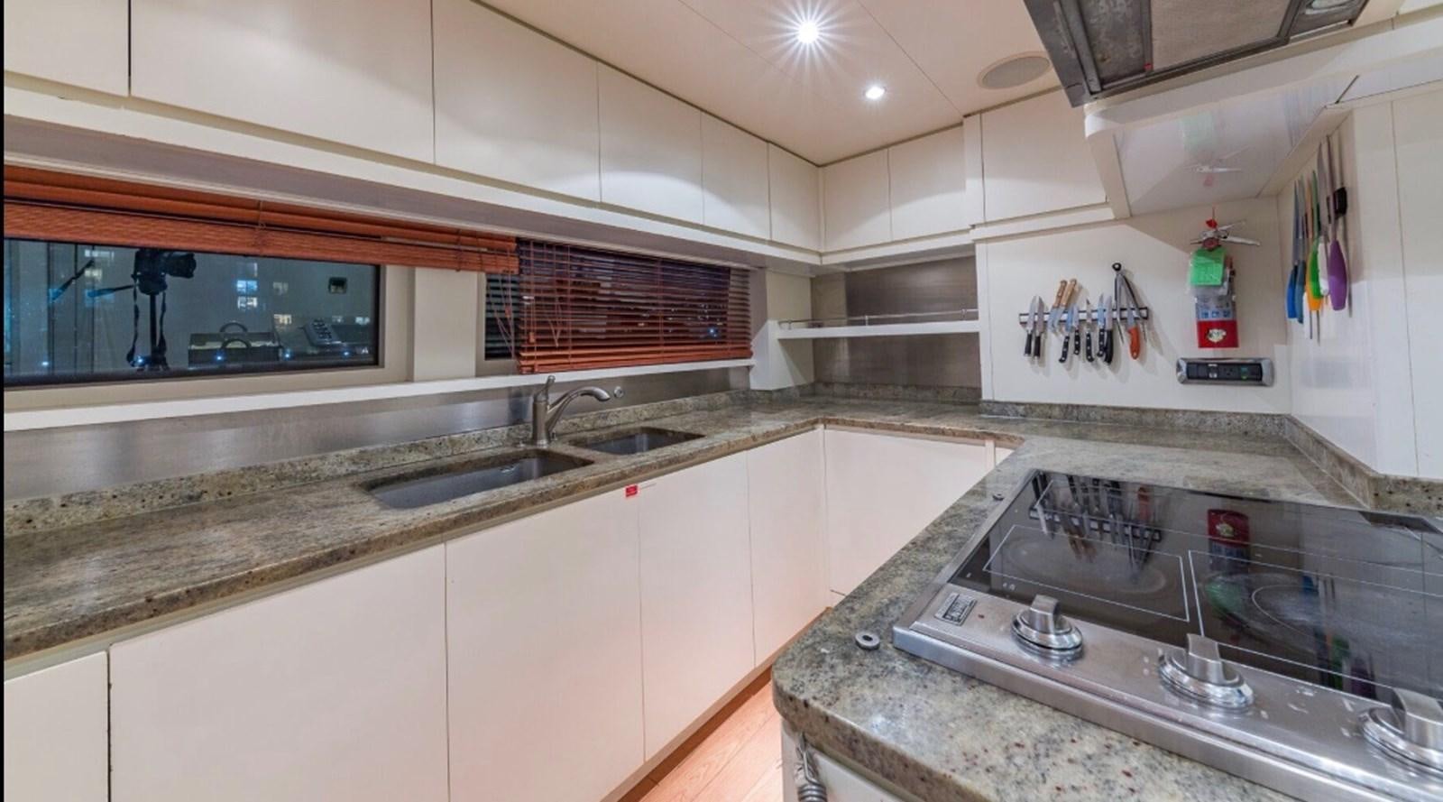 a kitchen with a sink and a stove aboard AVA Yacht for Sale