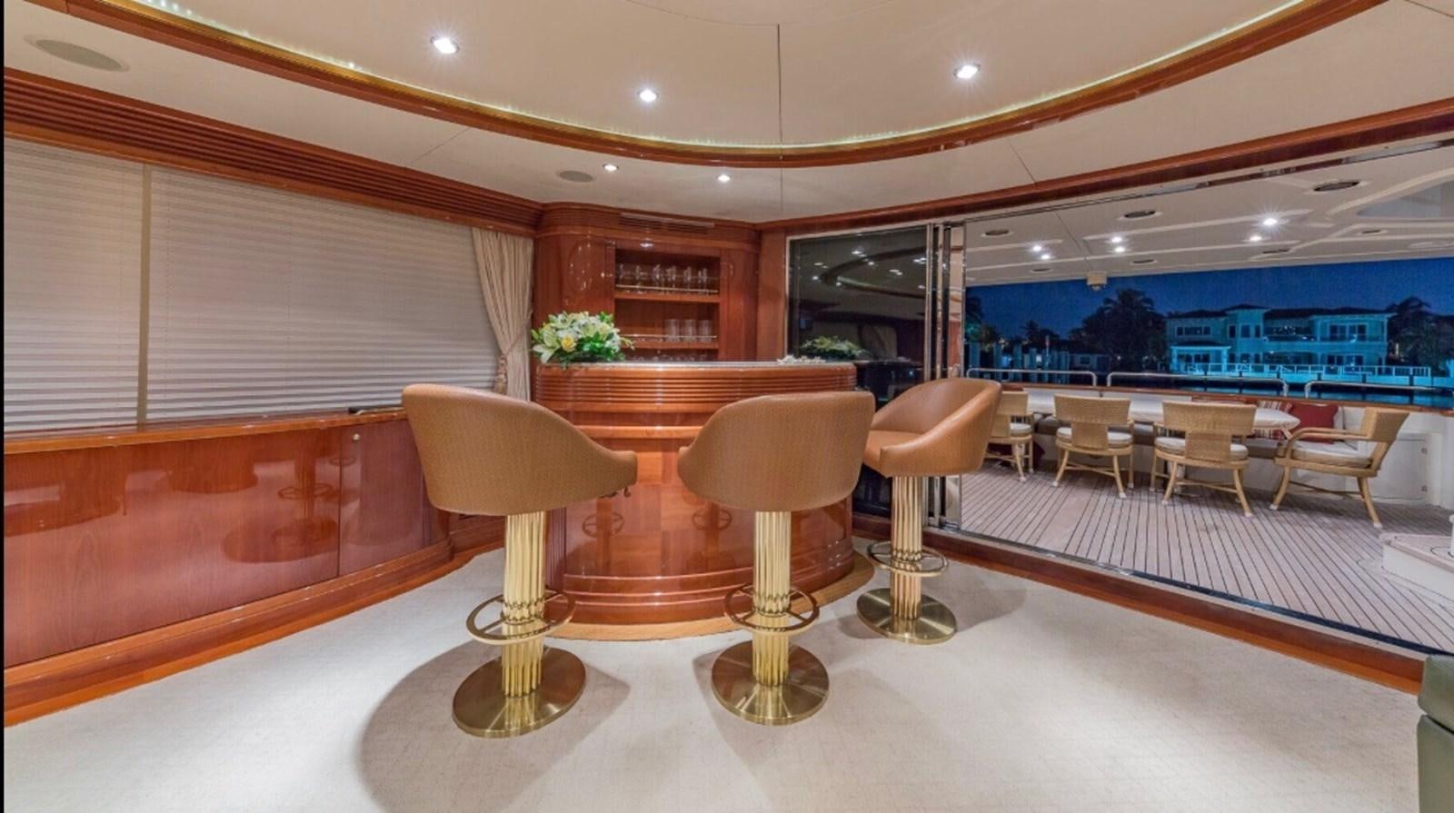 a room with tables and chairs aboard AVA Yacht for Sale