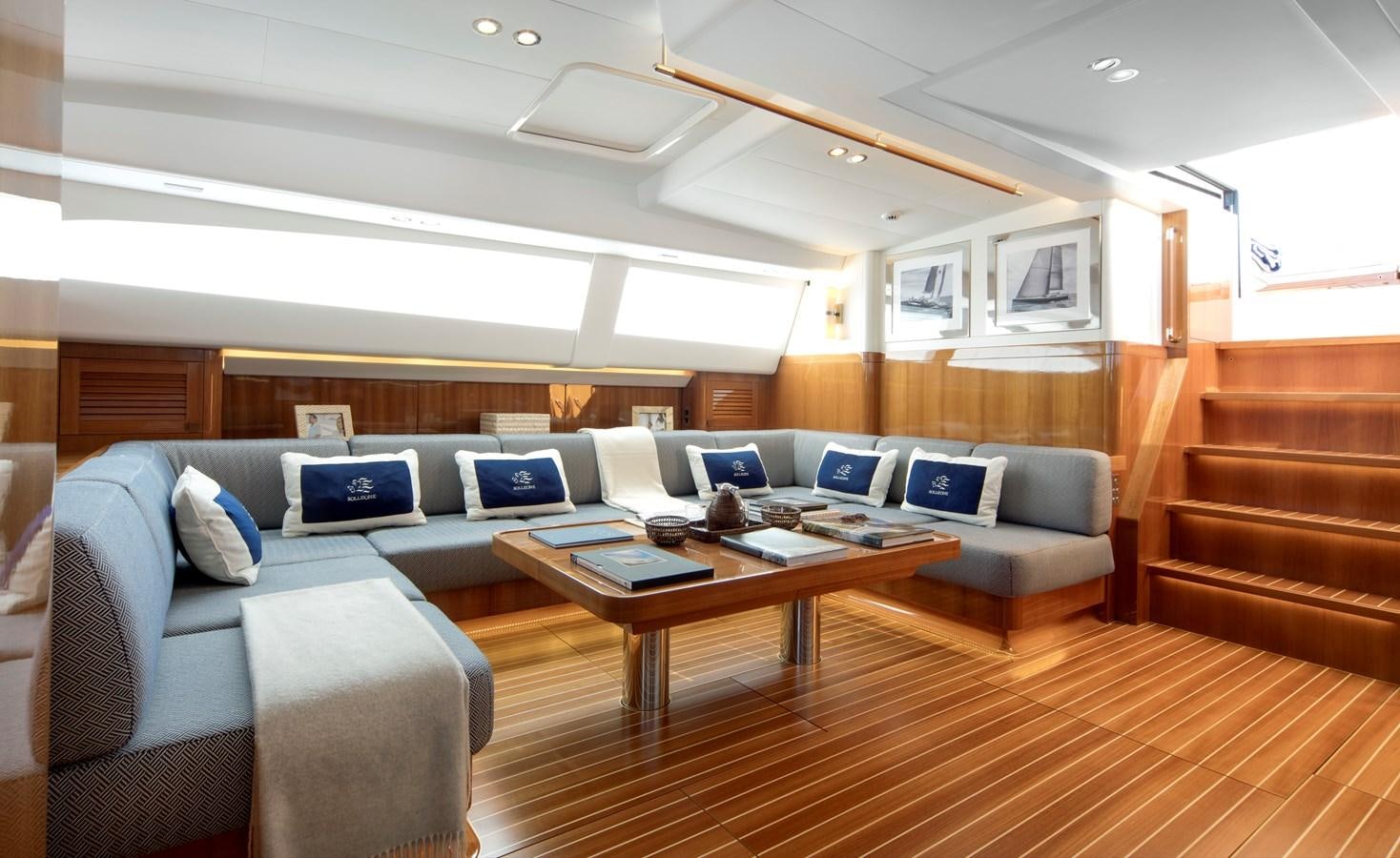 a living room with a couch and a coffee table aboard SOLLEONE Yacht for Sale