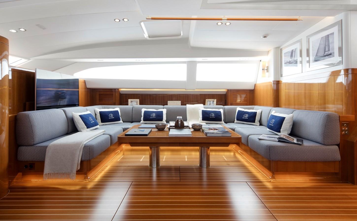 a room with a couch and a table with laptops on it aboard SOLLEONE Yacht for Sale
