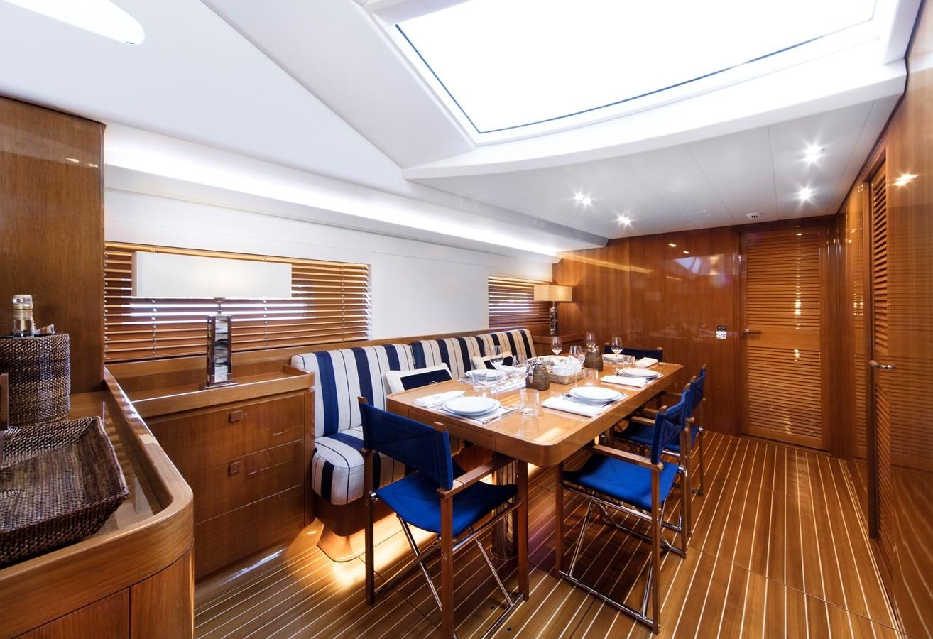a dining room with a table and chairs aboard SOLLEONE Yacht for Sale