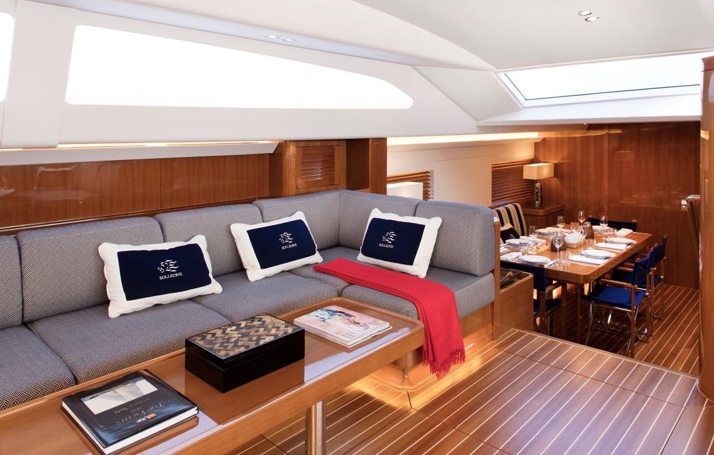 a living room with a couch and a table aboard SOLLEONE Yacht for Sale