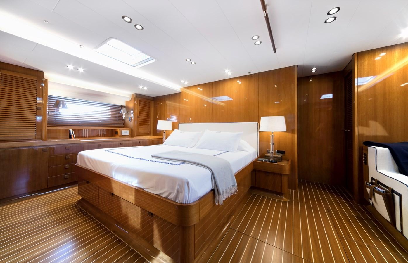 a room with a bed and a table aboard SOLLEONE Yacht for Sale