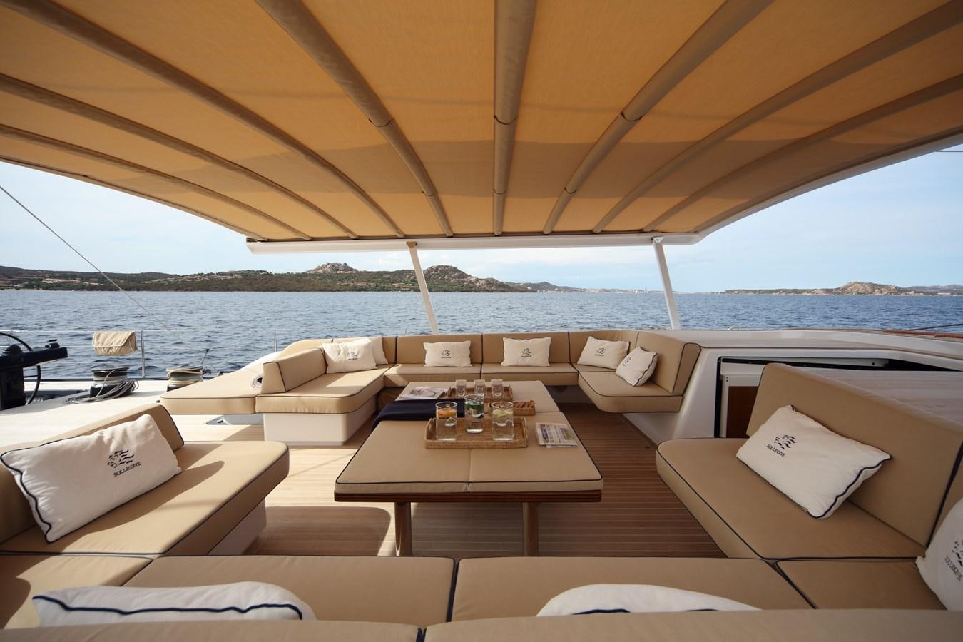 a room with a table and chairs aboard SOLLEONE Yacht for Sale