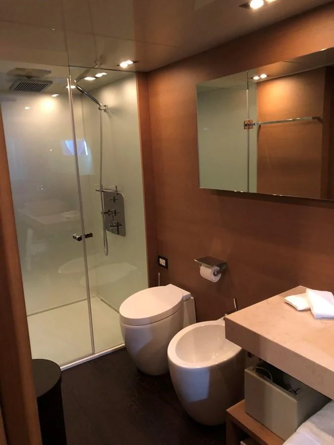 a bathroom with a glass shower door aboard IL GATTOPARDO Yacht for Sale