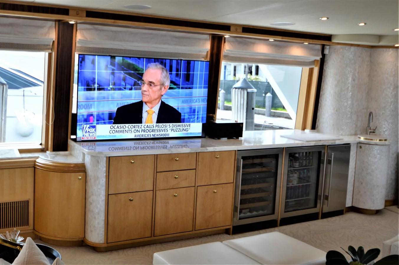 a person on a television screen in a kitchen aboard MISS STEPHANIE Yacht for Sale