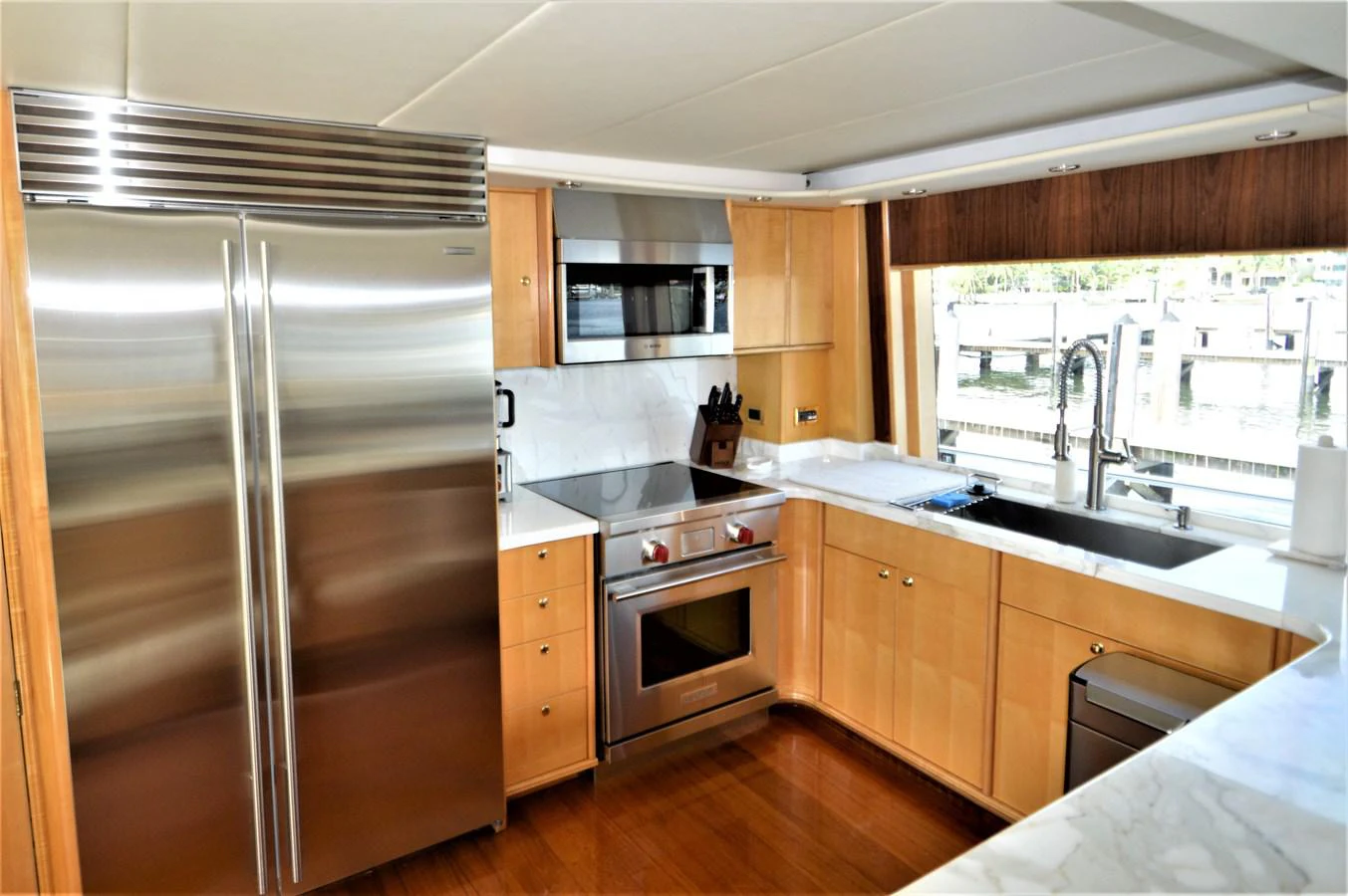 a kitchen with a stainless steel refrigerator aboard MISS STEPHANIE Yacht for Sale