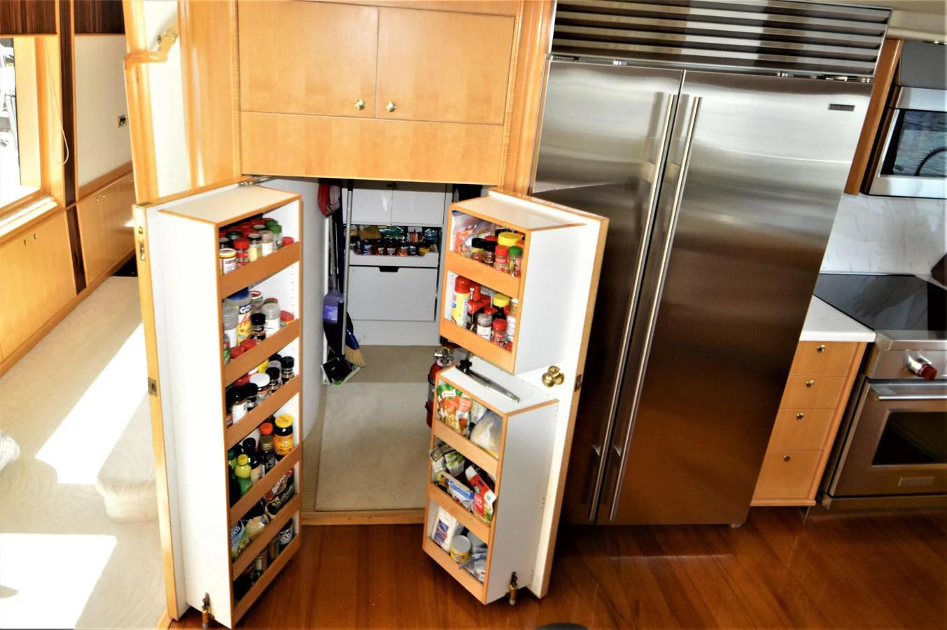 a kitchen with a refrigerator and a freezer unit aboard MISS STEPHANIE Yacht for Sale