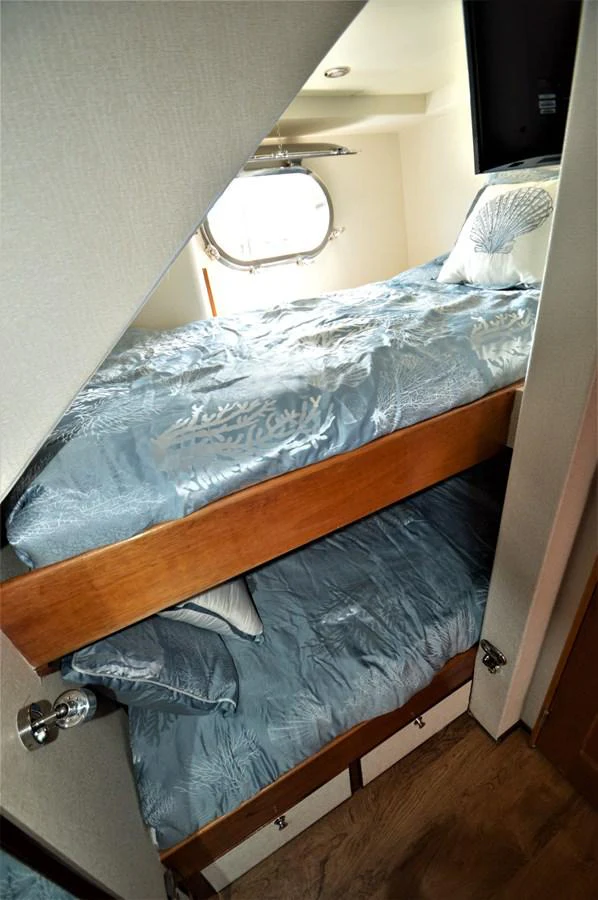 a bed with a mirror above it aboard MISS STEPHANIE Yacht for Sale