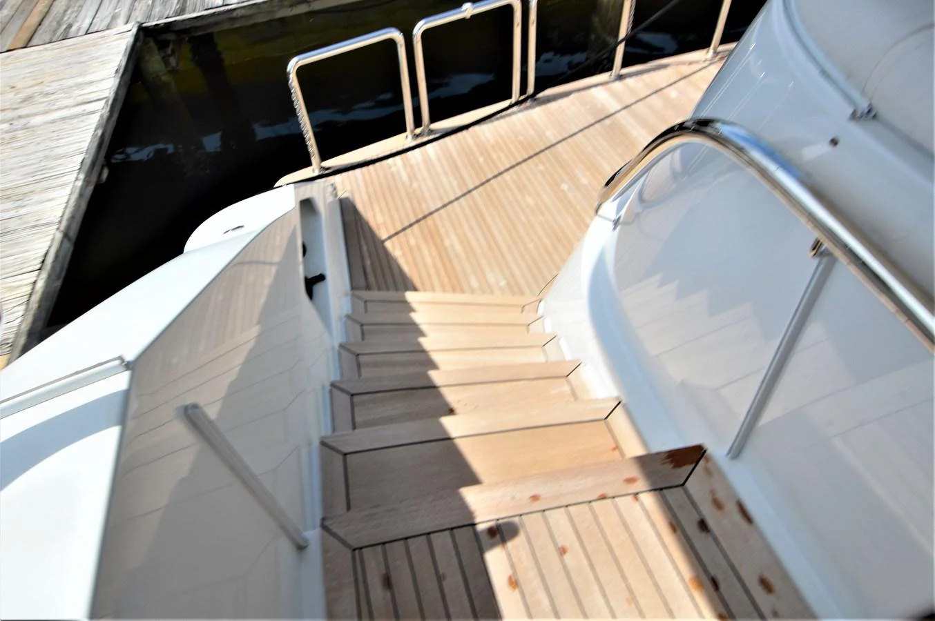 a wooden staircase with a railing aboard MISS STEPHANIE Yacht for Sale