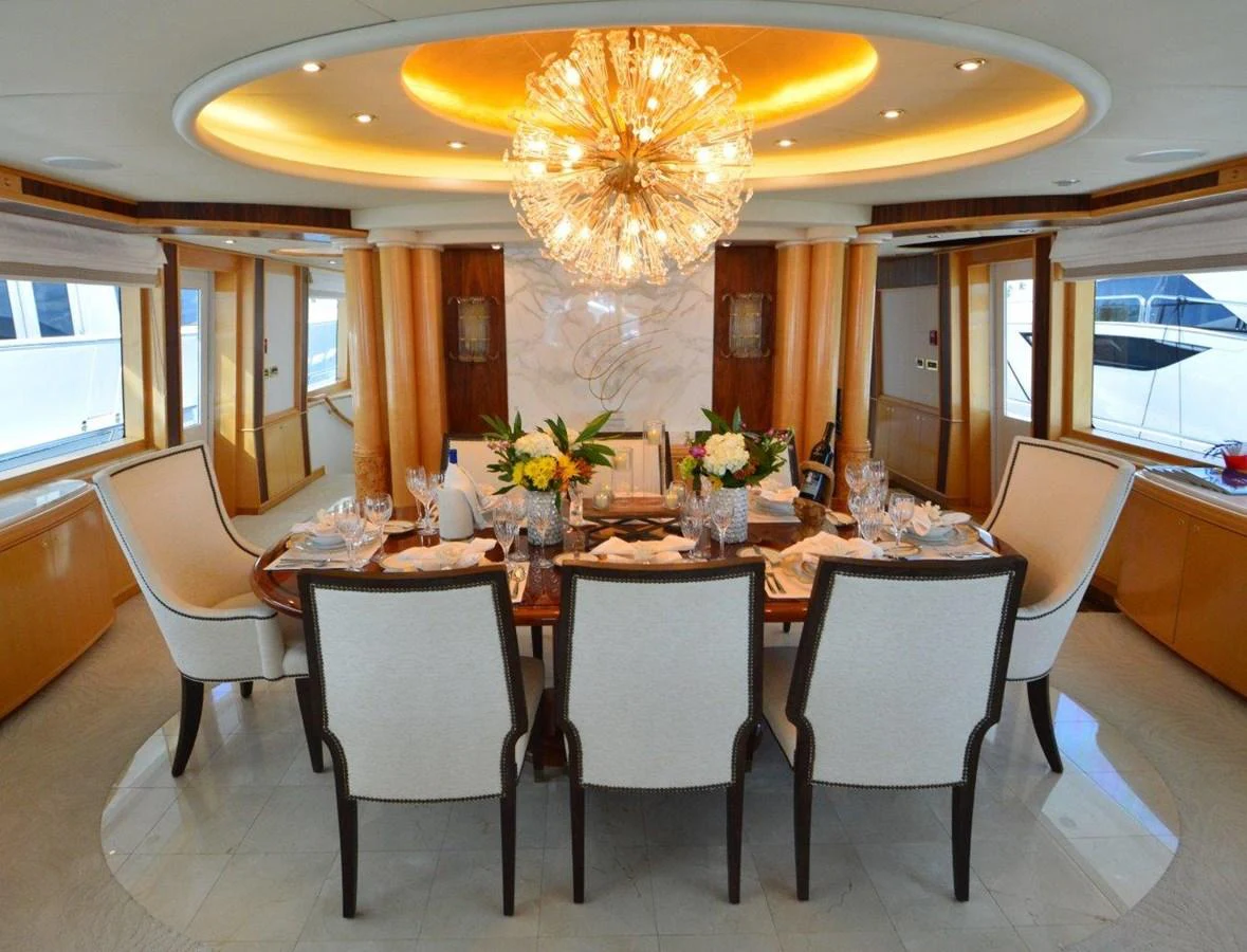 a large dining table with white chairs aboard MISS STEPHANIE Yacht for Sale