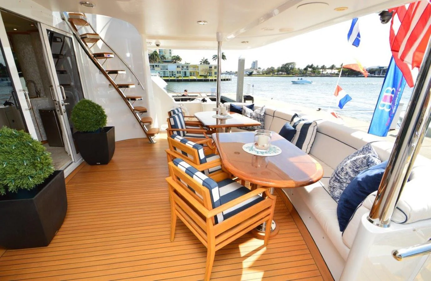 a room with a table chairs and plants on the side aboard MISS STEPHANIE Yacht for Sale