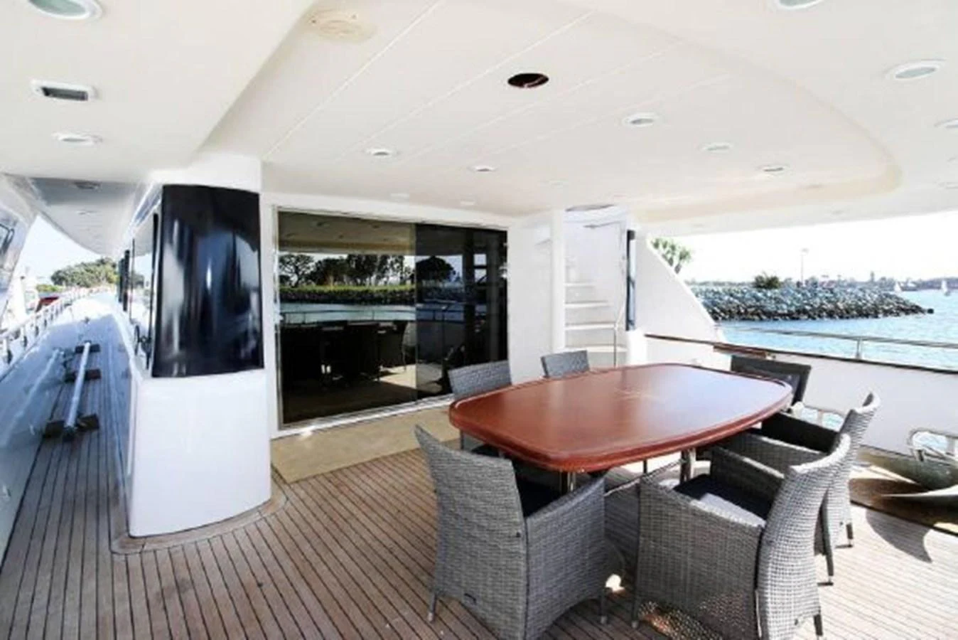 a table and chairs on a deck aboard AMADEUS Yacht for Sale