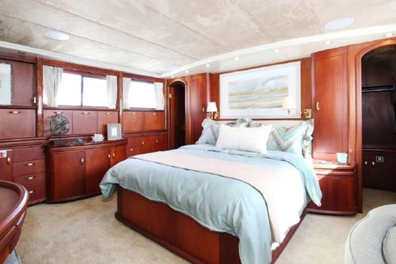a bedroom with a bed and cabinets aboard AMADEUS Yacht for Sale