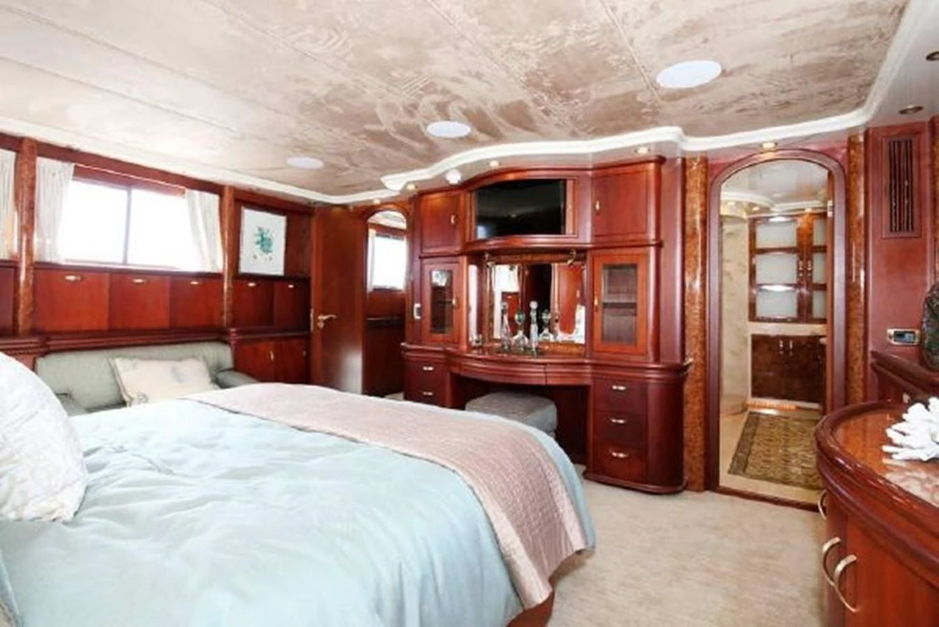 a bedroom with a bed and a closet aboard AMADEUS Yacht for Sale