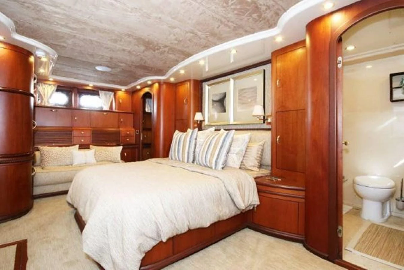 a bedroom with a bed and a closet aboard AMADEUS Yacht for Sale