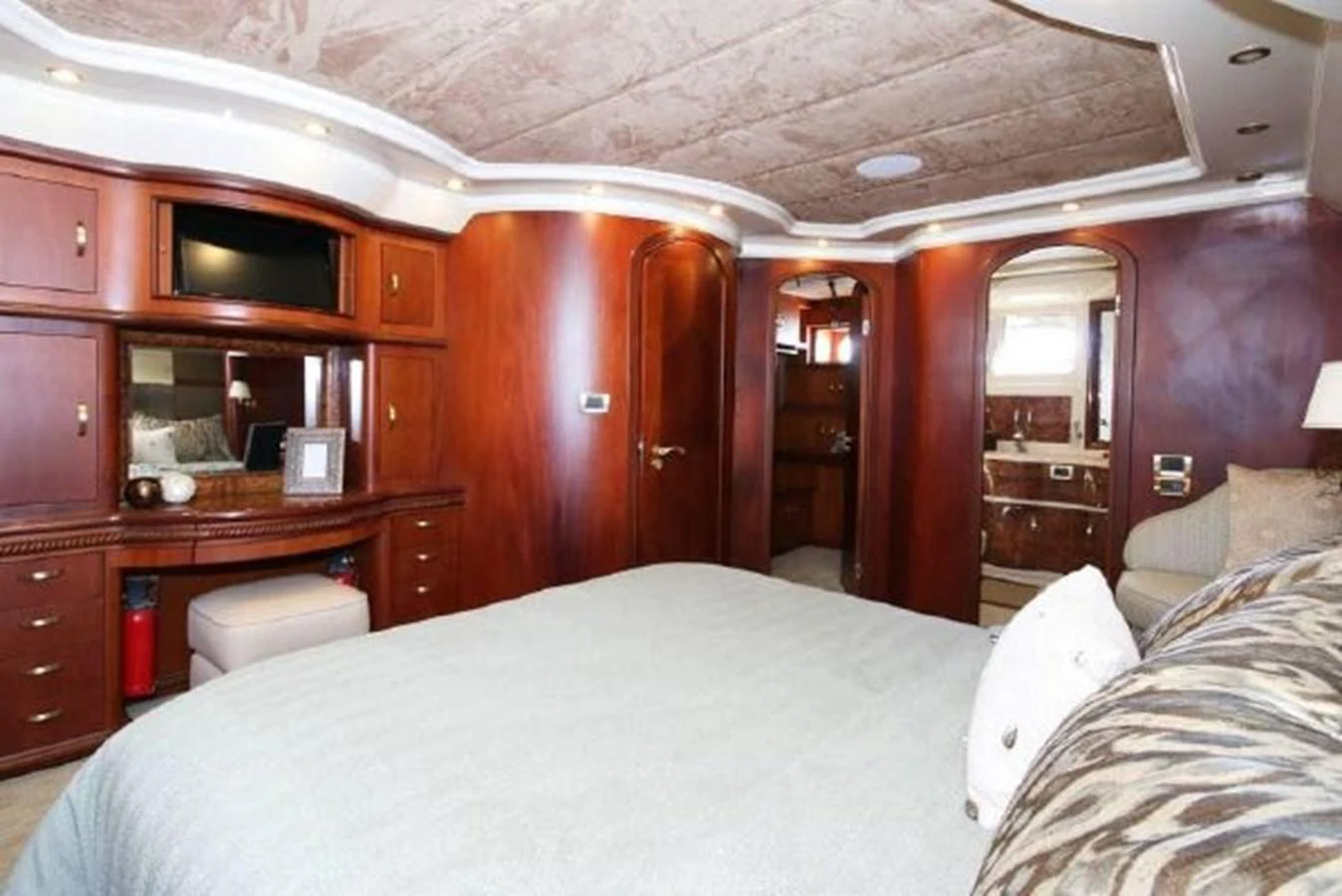 a bedroom with a bed and a desk aboard AMADEUS Yacht for Sale