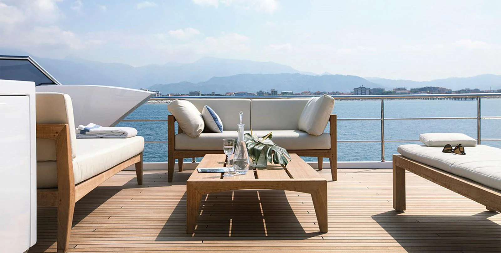 a table and chairs on a deck overlooking a body of water aboard VICIOUS RUMOUR II Yacht for Sale