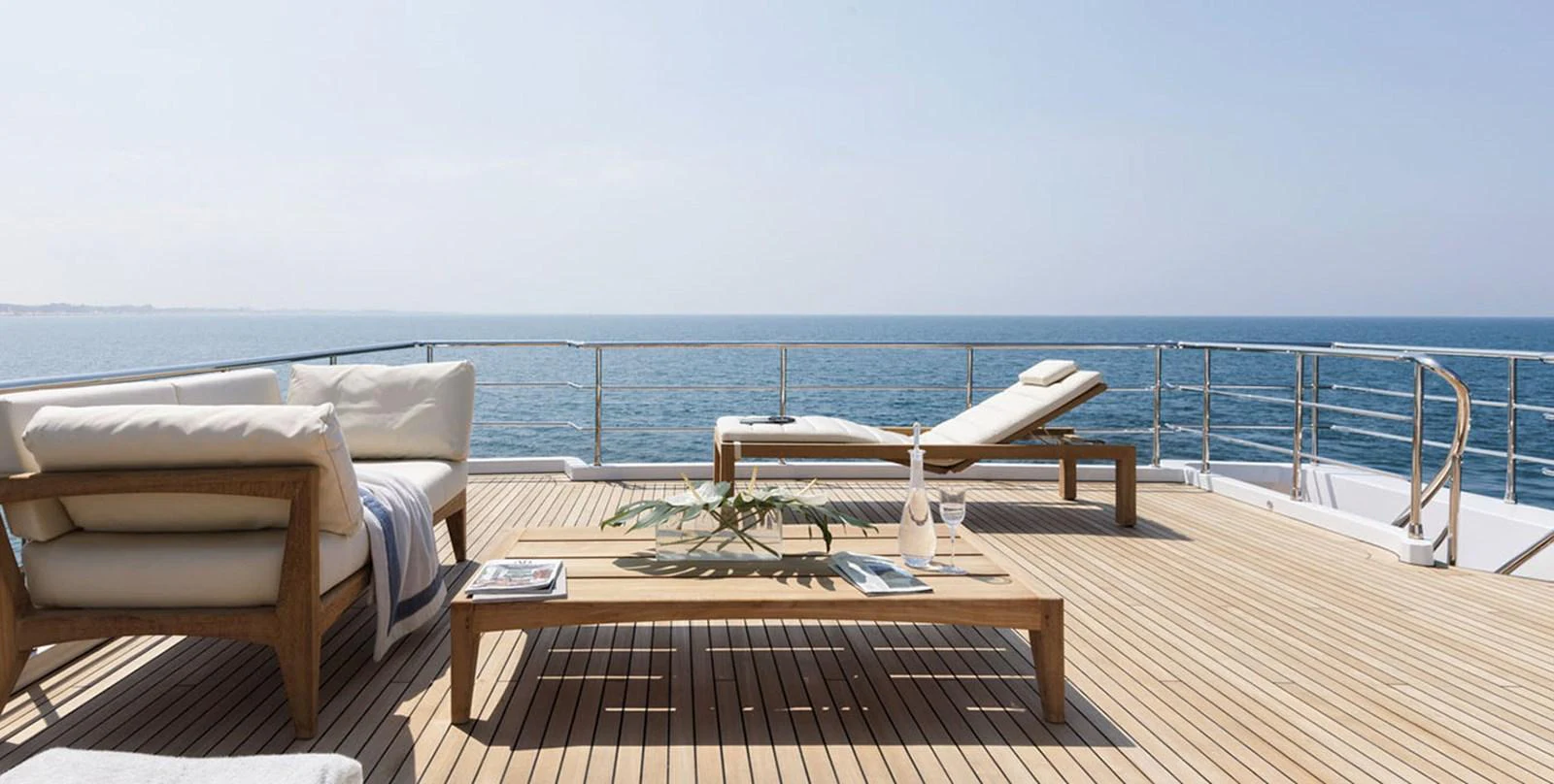 a deck with a table and chairs on it aboard VICIOUS RUMOUR II Yacht for Sale
