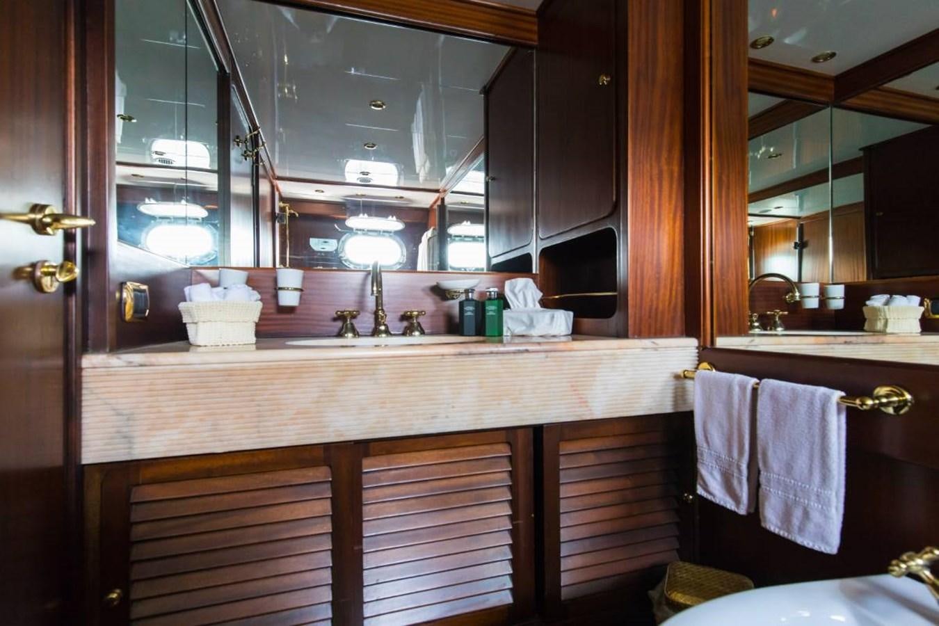 a kitchen with a countertop sink and cabinets aboard INDIA Yacht for Sale