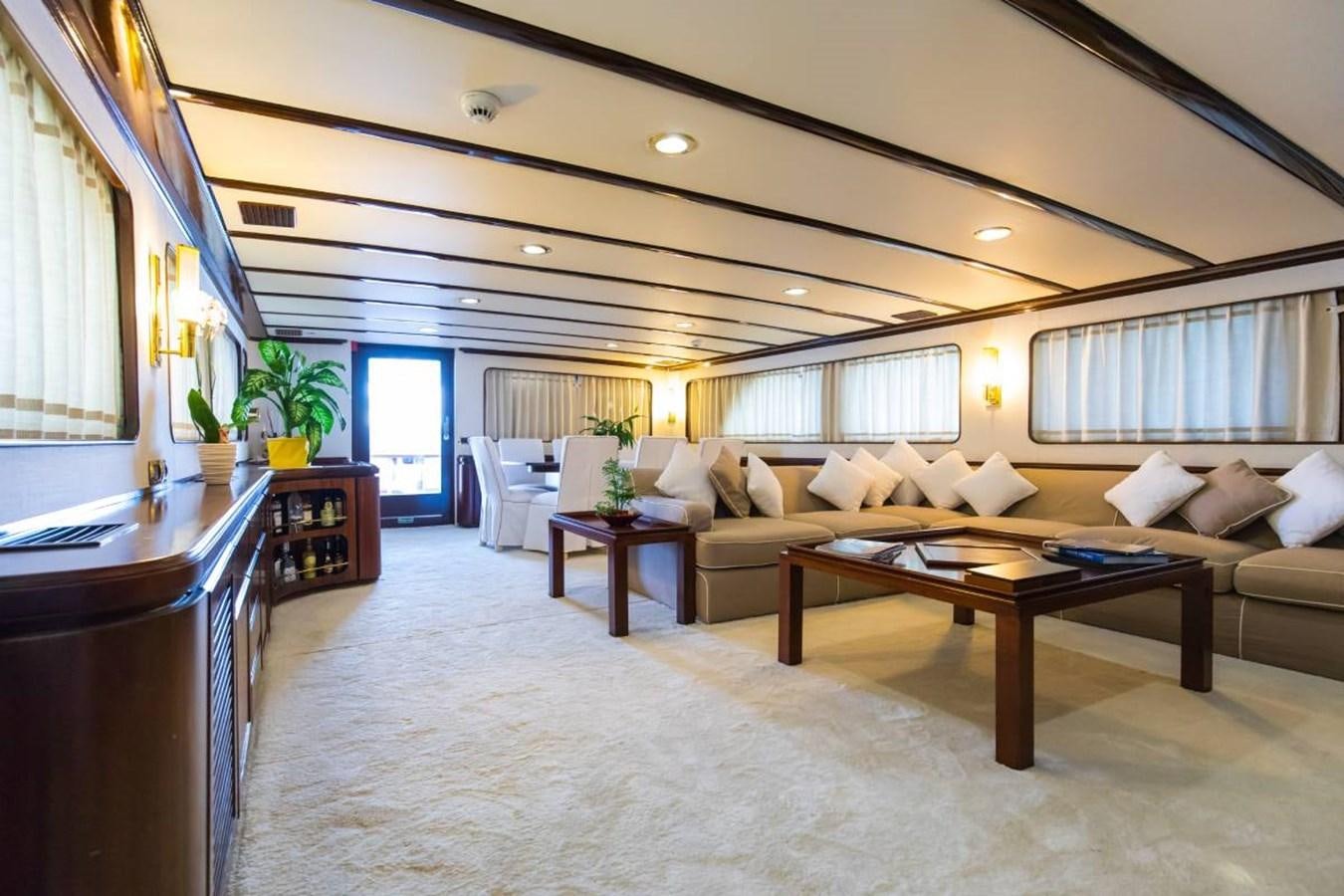 a living room with a couch and a coffee table aboard INDIA Yacht for Sale