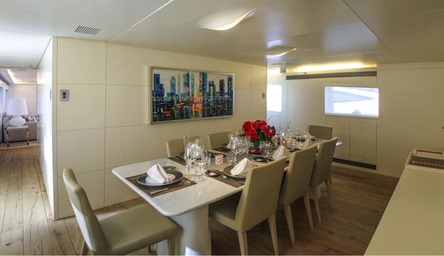 a table with chairs and a vase of flowers on it aboard ADMIRAL 35 Yacht for Sale