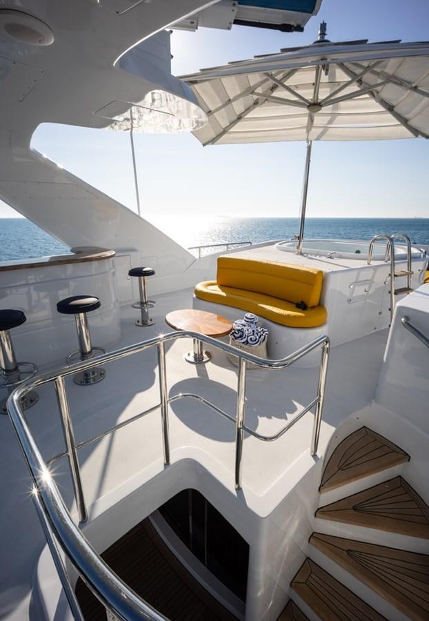 a boat with a sink and a large umbrella on the deck aboard SERENO Yacht for Sale