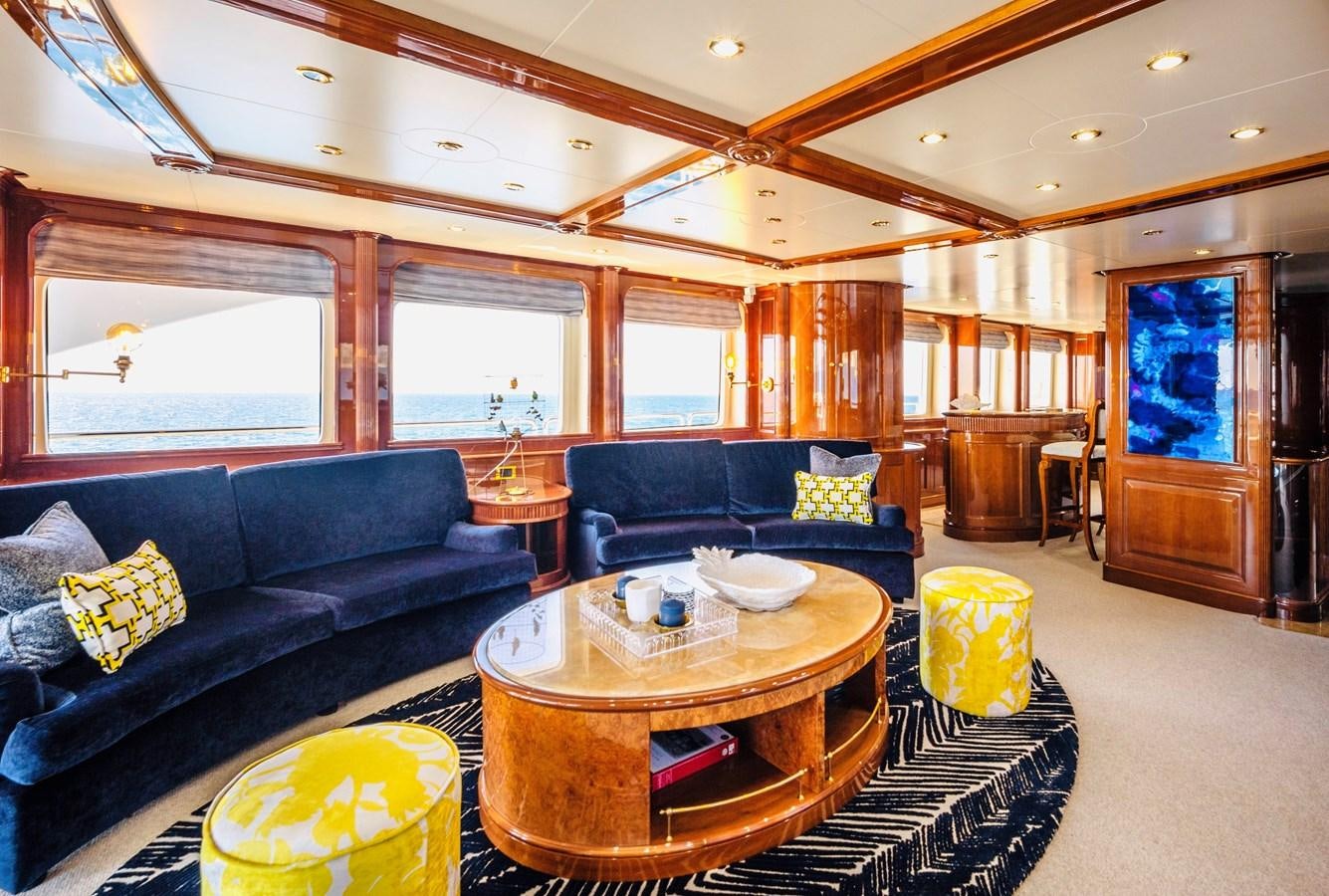 a living room with a leather couch and a wood table aboard SERENO Yacht for Sale