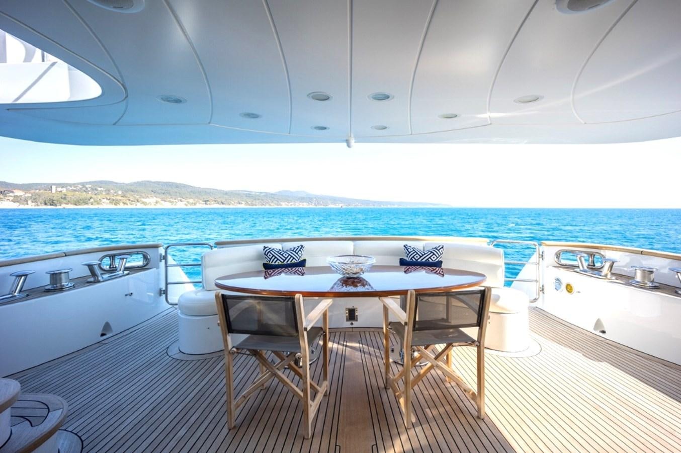 a table and chairs on a deck aboard SERENO Yacht for Sale
