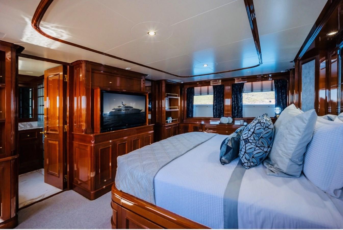 a bedroom with a bed and a television aboard SERENO Yacht for Sale