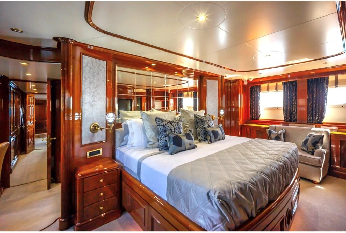 a bedroom with a bed and a mirror aboard SERENO Yacht for Sale