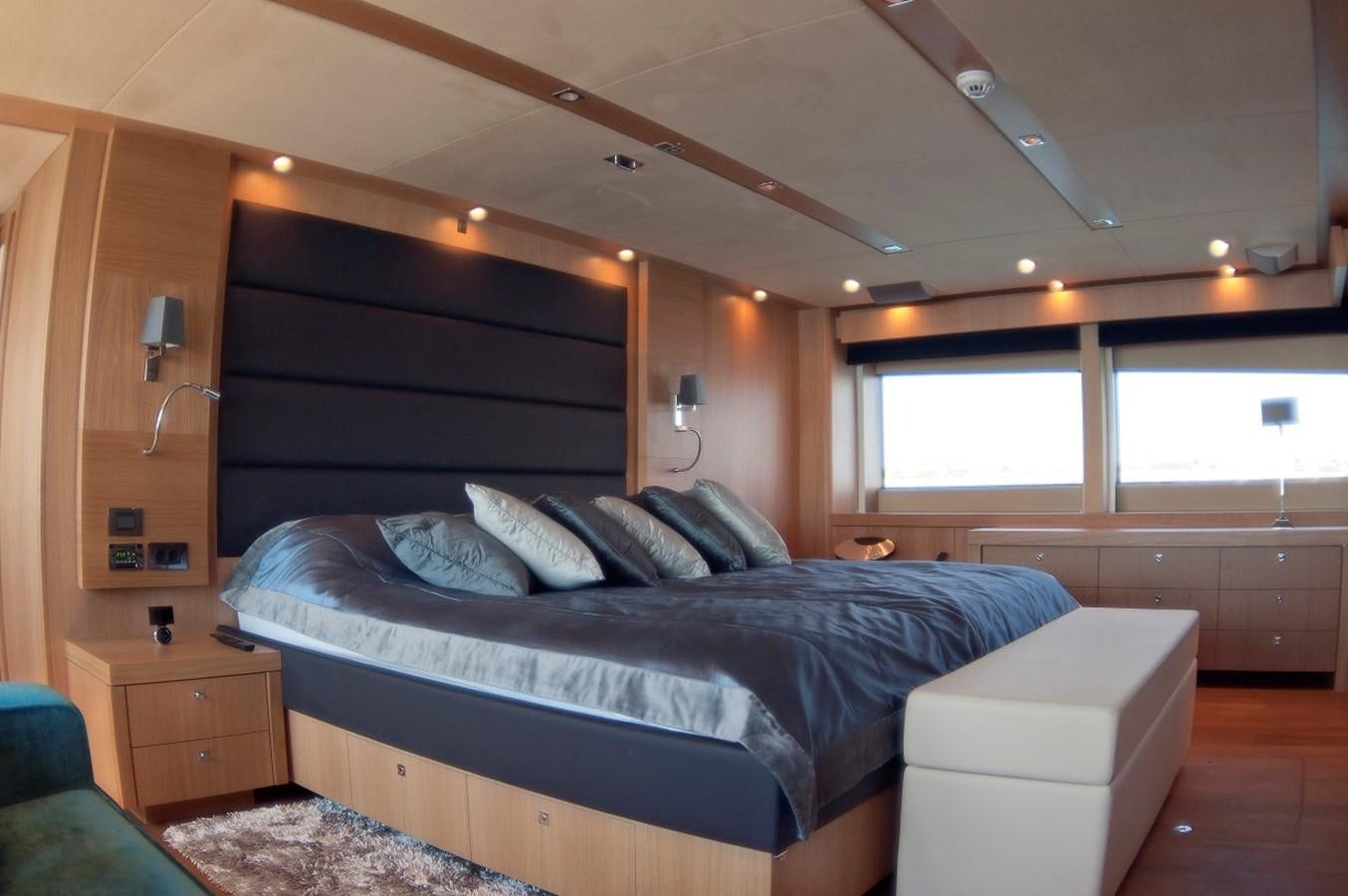 a bedroom with a bed and a dresser aboard SUN FLOWER Yacht for Sale