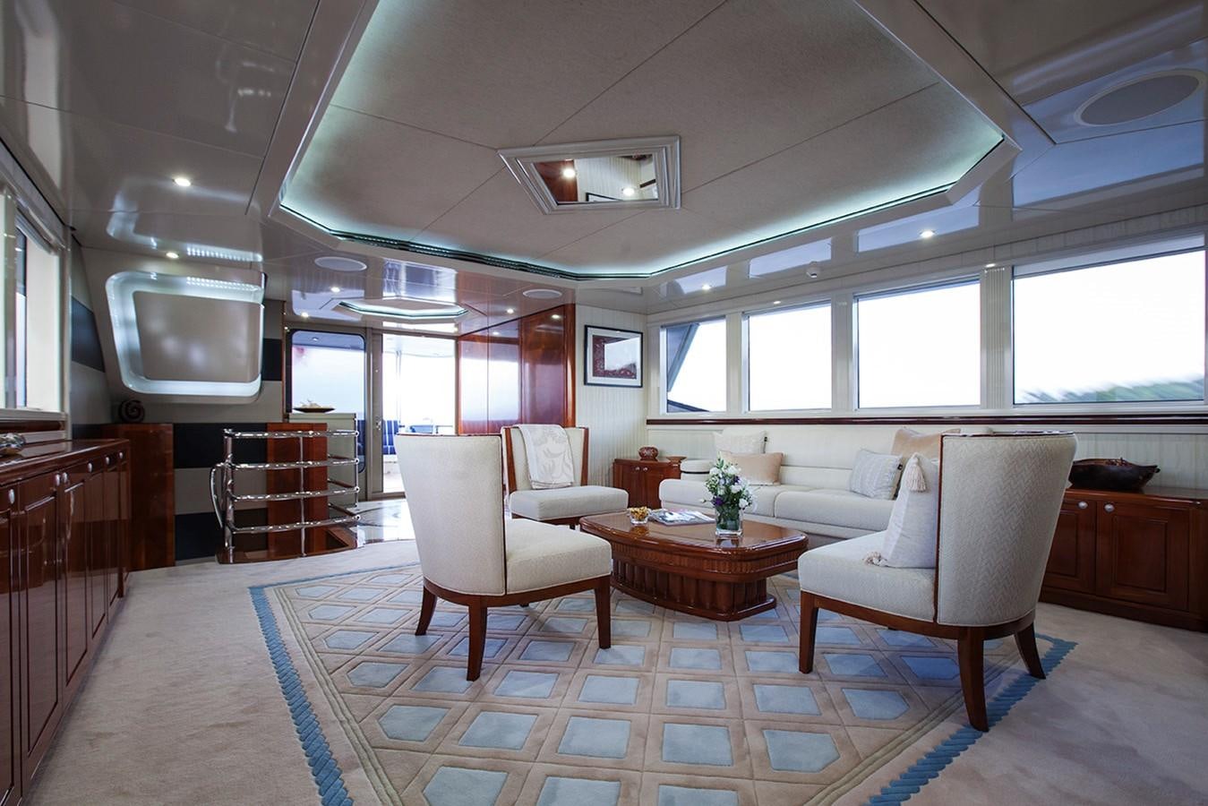 a living room with a table and chairs aboard PRINCESS ILUKA Yacht for Sale