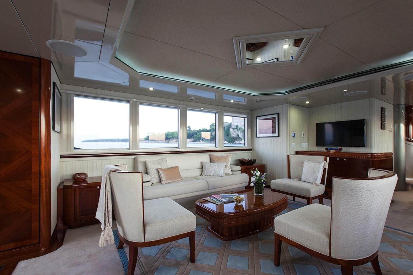 a living room with white furniture aboard PRINCESS ILUKA Yacht for Sale