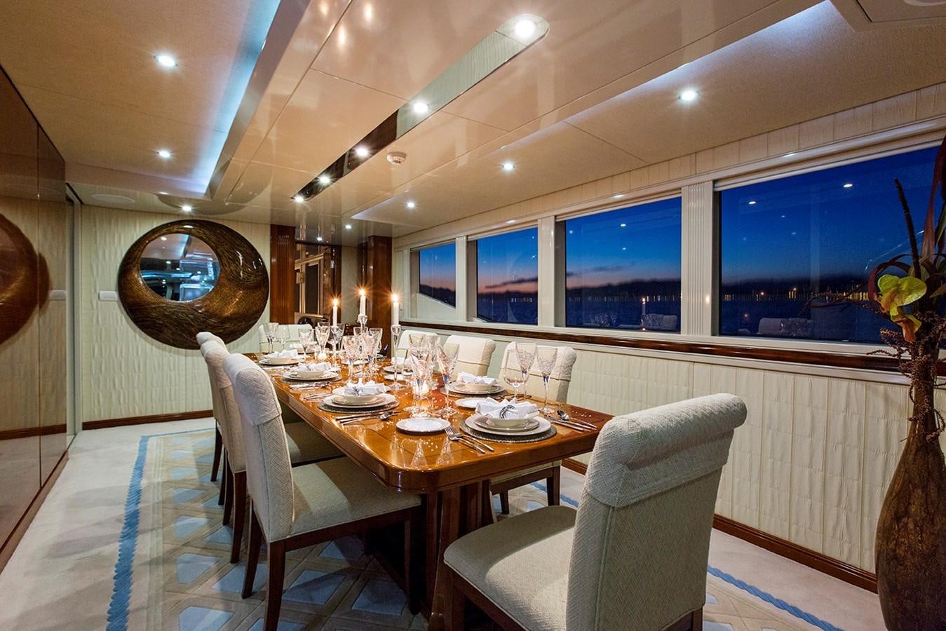a dining room with a table and chairs aboard PRINCESS ILUKA Yacht for Sale