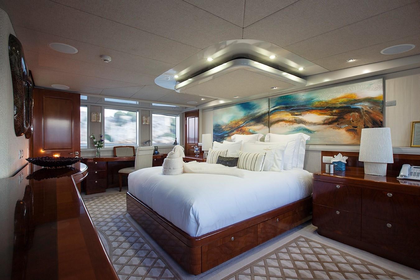 a room with a bed and a desk aboard PRINCESS ILUKA Yacht for Sale