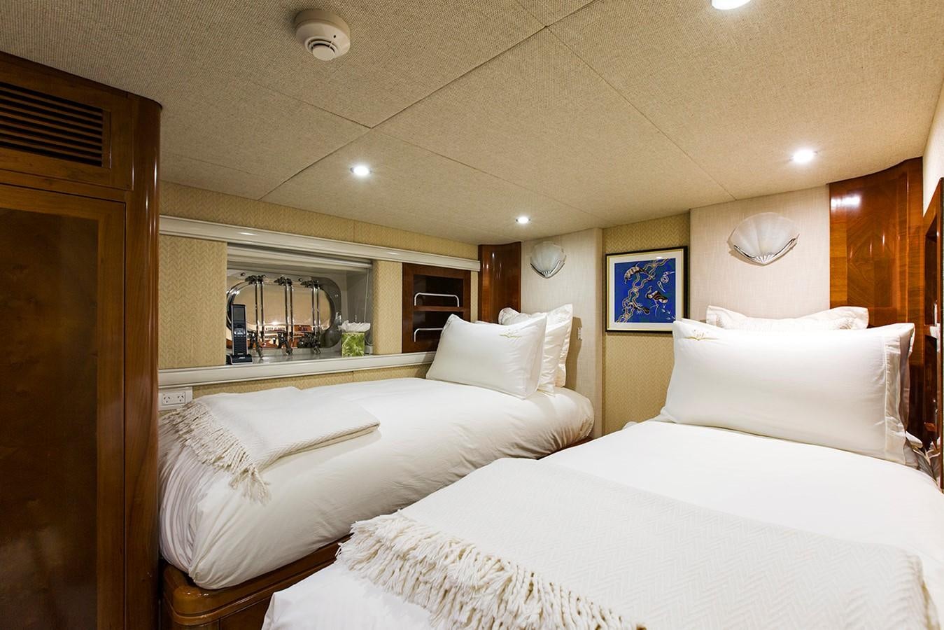 a room with a couple of beds aboard PRINCESS ILUKA Yacht for Charter