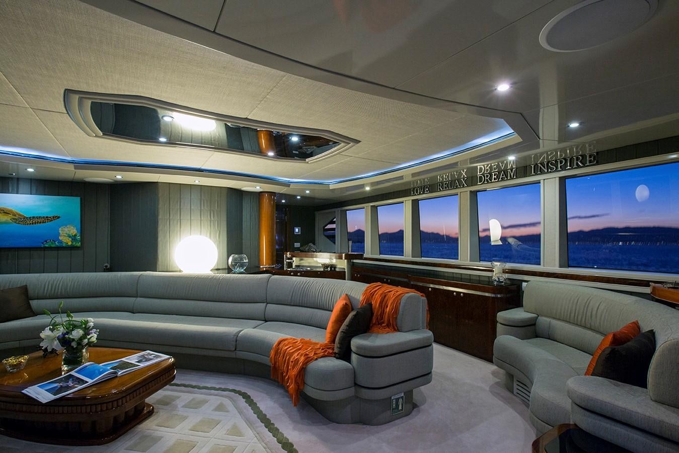 a living room with a large screen aboard PRINCESS ILUKA Yacht for Sale