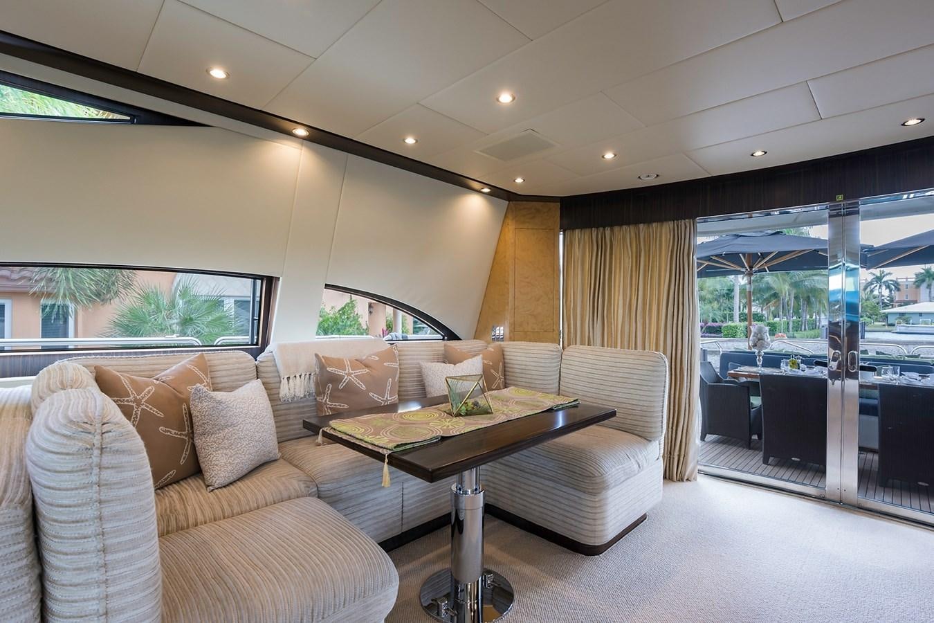 a living room with a table and couches aboard 34M LEOPARD Yacht for Sale