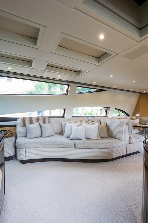 a large white bed with a white couch and a large window aboard 34M LEOPARD Yacht for Sale