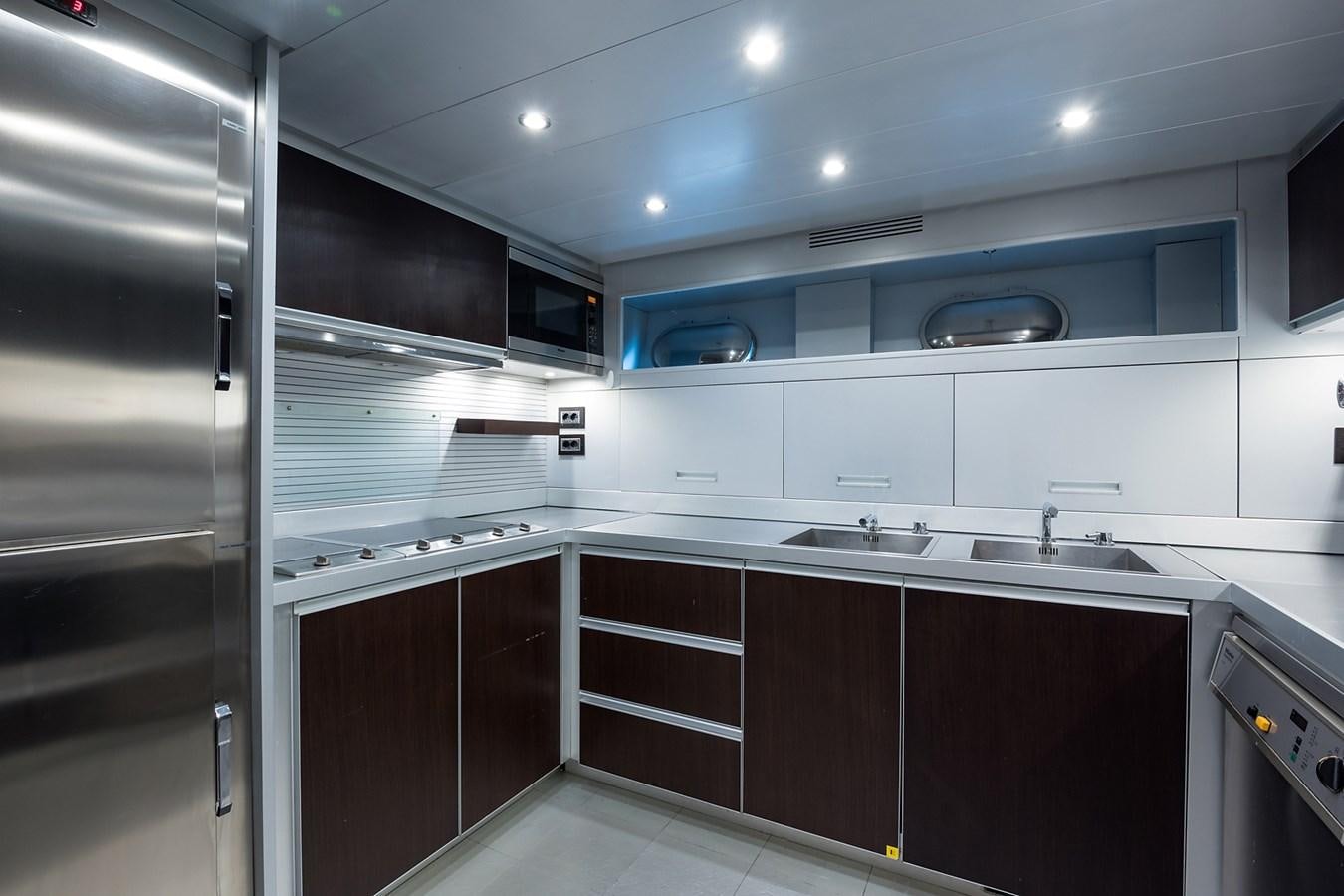 a kitchen with a sink and cabinets aboard 34M LEOPARD Yacht for Sale